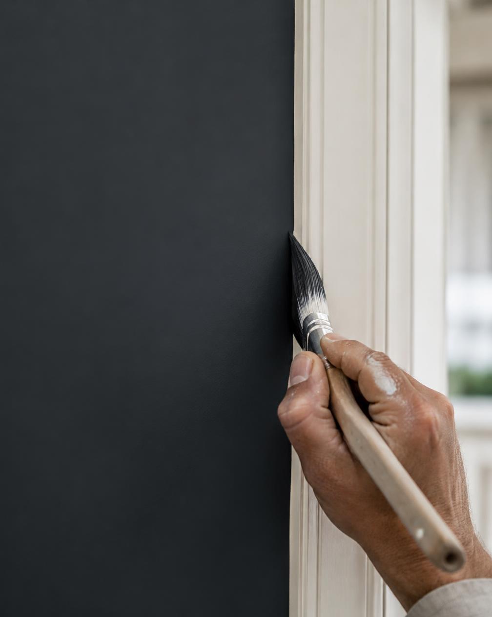 Painter cutting a clean line along white trim (representative image)